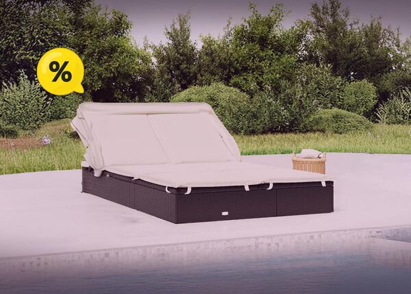 Double sun lounger made of rattan with closed canopy in a garden setting, large yellow discount symbols in corners.